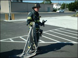 Figure 2 - Here, the nozzle firefighter has the nozzle and 50 feet of hose that he will bring to the drop point. The nozzle firefighter drops the 50 feet in an area that is relatively close to the fire&apos;s location, but not so close that the team is in an IDLH environment. The drop point uses compartmentation, elevation, or exterior advantages to stretch the line dry. This allows for a much quicker stretch but without placing the members in danger. The drop point also should offer enough room to flake out the line so as to prevent kinks.