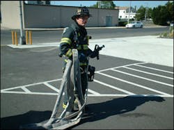 Figure 2 - Here, the nozzle firefighter has the nozzle and 50 feet of hose that he will bring to the drop point. The nozzle firefighter drops the 50 feet in an area that is relatively close to the fire's location, but not so close that the team is in an IDLH environment. The drop point uses compartmentation, elevation, or exterior advantages to stretch the line dry. This allows for a much quicker stretch but without placing the members in danger. The drop point also should offer enough room to flake out the line so as to prevent kinks. Figure 2 - Here, the nozzle firefighter has the nozzle and 50 feet of hose that he will bring to the drop point. The nozzle firefighter drops the 50 feet in an area that is relatively close to the fire's location, but not so close that the team is in an IDLH environment. The drop point uses compartmentation, elevation, or exterior advantages to stretch the line dry. This allows for a much quicker stretch but without placing the members in danger. The drop point also should offer enough room to flake out the line so as to prevent kinks.