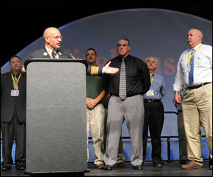 FDNY Chief Sal Cassano recognizes Firehouse Expo presenters at the end of the opening ceremonies.