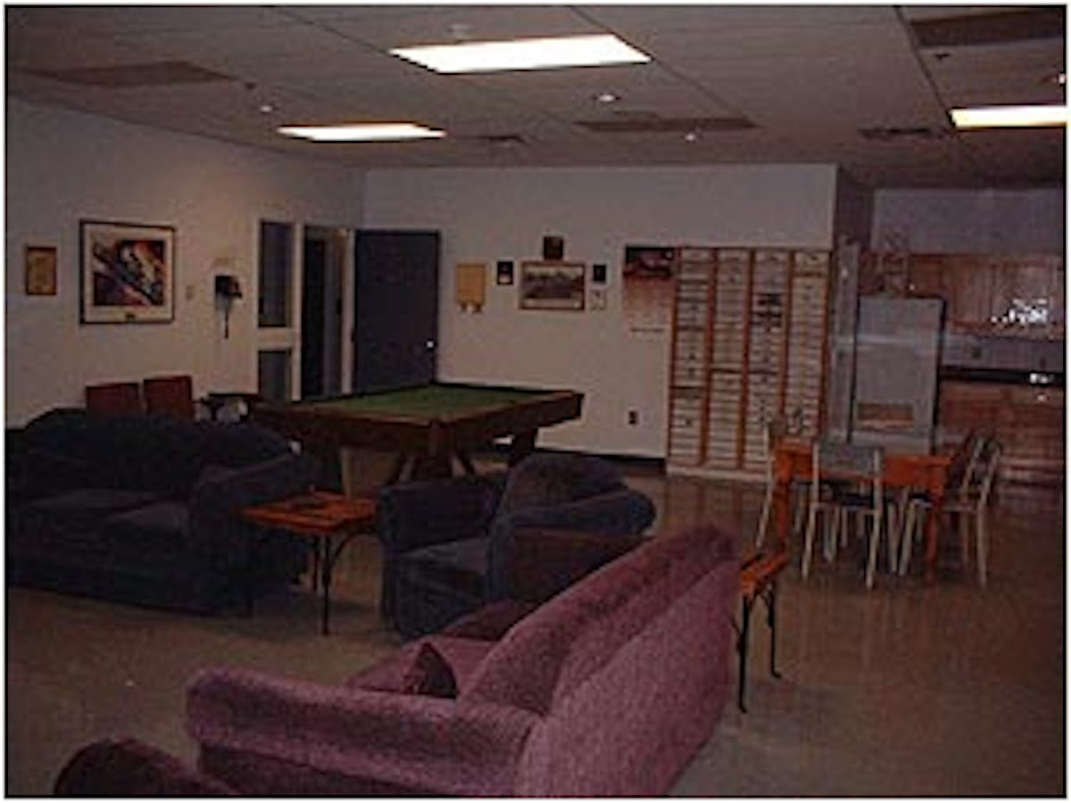 View of the crew lounge. This room has a 54 big screen TV, VCR, satellite reciever, and pool table. There is also an eating area for ten firefighters and a kitchenette. Stored in this room are 300 fire department patches from all over the world.Photos by Mike Ward