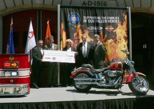 NFFF Director Ron Siarnicki (left) accepts the check from Pierce's Wilson Jones and Harley Davidson's Steve St Thomas.