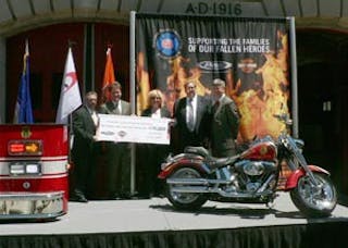 NFFF Director Ron Siarnicki (left) accepts the check from Pierce&apos;s Wilson Jones and Harley Davidson&apos;s Steve St Thomas.