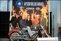 Mark Jones, vice president of sales and service for Pierce dealership Ten-8 Fire Equipment Inc. of Bradenton, Fla. received the keys to a custom, one-of-a-kind Harley-Davidson Fat Boy Firefighter Special Edition motorcycle. Behind Mark (left to right): Bill Davidson, Harley-Davidson Motor Company; Wilson Jones, Oshkosh Corporation; Allyson Murphy, National Fallen Firefighters Foundation; Joe Pritchard, Pritchard Chassis Corporation; and Ron Siarnicki, National Fallen Firefighters Foundation.