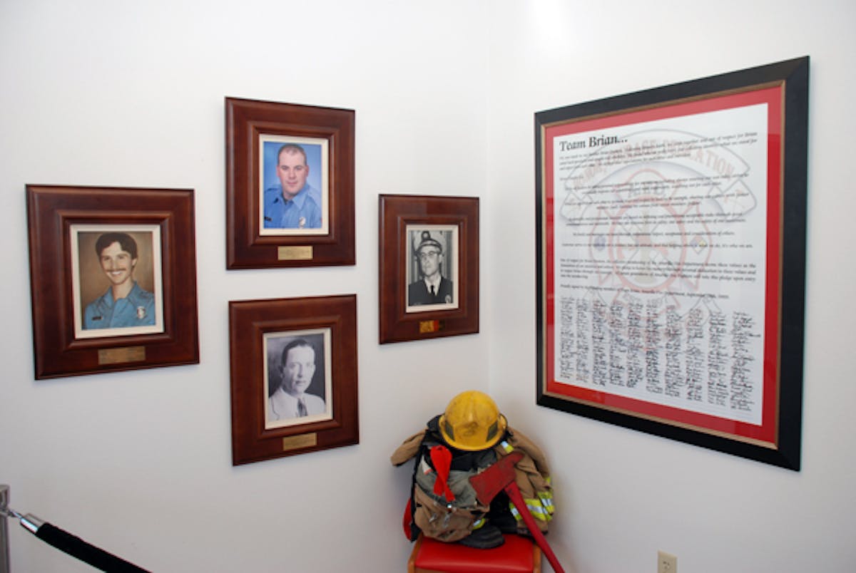A Team Brian Poster, with signatures from all members of the Amarillo Fire Department hangs on the wall of the station. The three photos memorialize the department&apos;s four line of duty deaths, including Brian Hunton, who is top center.