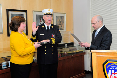 Fire Commissioner Salvatore Cassano administers the Oath of Office to Edward Kilduff, who was sworn in as the FDNY's 34th Chief of Department with his wife, Kathy, at his side.