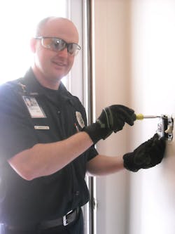 Firefighter/electrician, David Carpenter installs a GE Emergency Light Switch in a resident's home free of charge. Firefighter/electrician, David Carpenter installs a GE Emergency Light Switch in a resident's home free of charge.