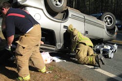 Pine Mountain firefighter JR Owens (left) and Fire Chief Tim Edgar maneuver in and around the wreckage of James Gunder’s Chevrolet Blazer, offering help to the occupants. Pine Mountain firefighter JR Owens (left) and Fire Chief Tim Edgar maneuver in and around the wreckage of James Gunder’s Chevrolet Blazer, offering help to the occupants.