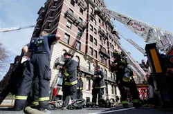 Firefighters regroup at the site of a 9-alarm fire on Beacon Street in Boston.