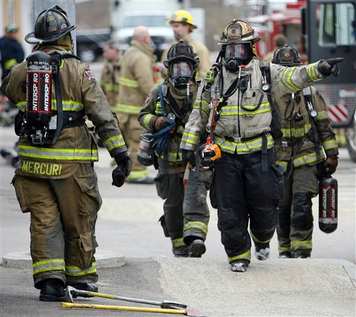 Firefighters are seen after battling a blaze where a meth lab in a house exploded during a police raid in Franklin, N.H.