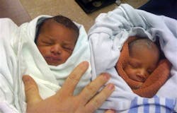 A set of boy and girl twins are bundled in towels at a Shawnee, Okla. fire station Saturday, May 1, 2010.