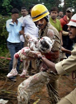 Indian firefighters carry a child, reportedly a survivor, out of the debris. Indian firefighters carry a child, reportedly a survivor, out of the debris.