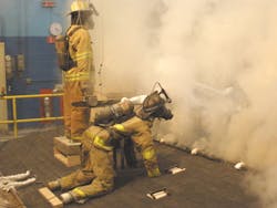 A modern lightweight metal gusset truss roof with a ceiling. This photo depicts significant volume and velocity of smoke during initial portions of the test. A modern lightweight metal gusset truss roof with a ceiling. This photo depicts significant volume and velocity of smoke during initial portions of the test.