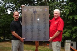 Erik Jones, left, presented Dr. Burt Clark with poster-size seat belt pledge signed by IAFF Local 3572. Erik Jones, left, presented Dr. Burt Clark with poster-size seat belt pledge signed by IAFF Local 3572.