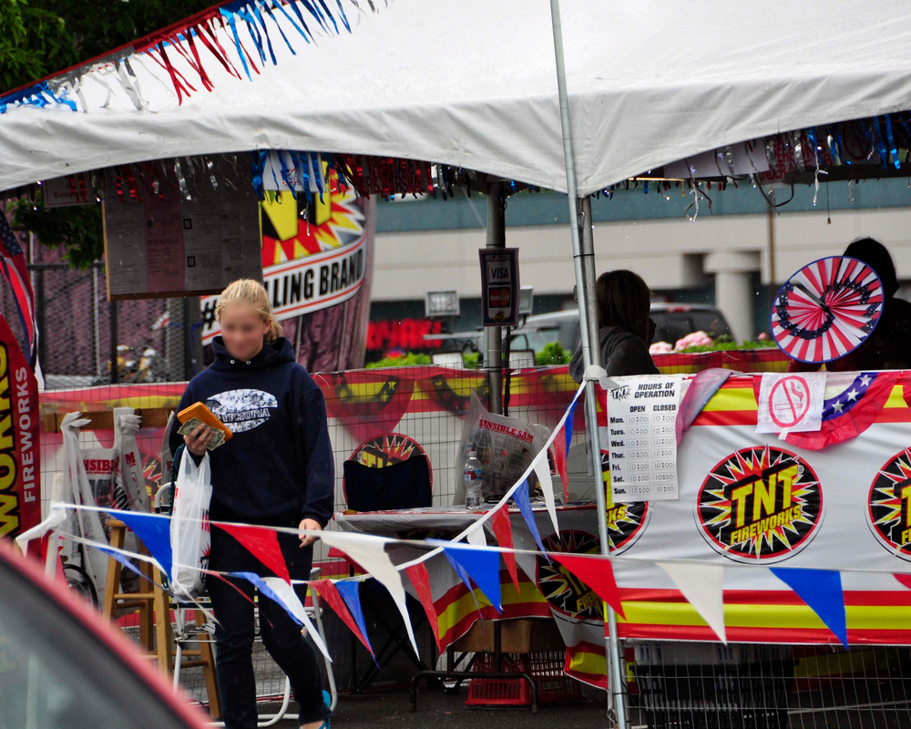 An under-age teen returns with a solo purchase of fireworks from a Hillsboro fireworks stand.