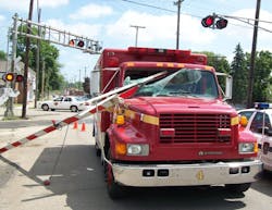 A Springfield firefighter was injured after a malfunctioning railroad crossing gate smashed into the windshield of an EMS unit on Aug. 5.