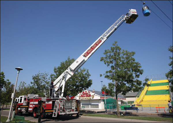Crews use Ladder 8's aerial ladder and bucket to access a simulated 'stranded cabin' along the Skyride route.