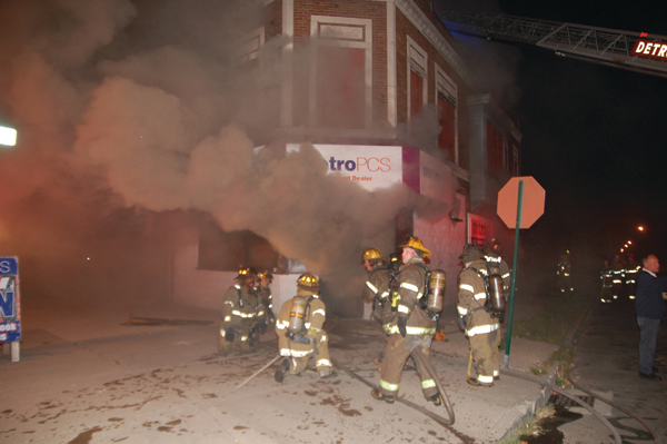 The initial line was advanced inside the store. Heavy fire conditions forced firefighters to back out before a second interior attack.