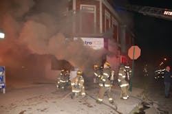 The initial line was advanced inside the store. Heavy fire conditions forced firefighters to back out before a second interior attack.