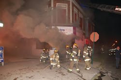 The initial line was advanced inside the store. Heavy fire conditions forced firefighters to back out before a second interior attack. The initial line was advanced inside the store. Heavy fire conditions forced firefighters to back out before a second interior attack.