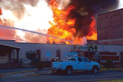 Heat from the fire pushed firefighters off the manned hoselines above the mini-storage building west of the fire. Thermal imagers were used by crews monitoring conditions inside adjacent exposures. Heat from the fire pushed firefighters off the manned hoselines above the mini-storage building west of the fire. Thermal imagers were used by crews monitoring conditions inside adjacent exposures.