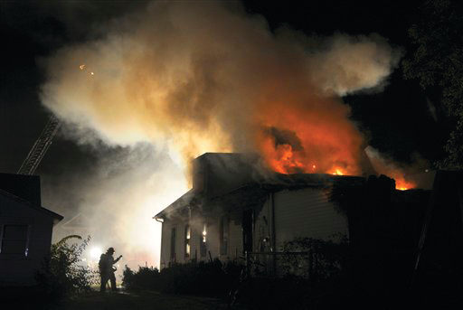 Salina firefighters rescued an elderly woman from the second-story window of a burning home and a man jumped from the roof.