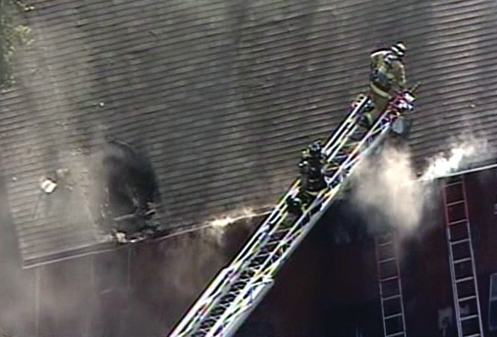 Firefighters battle a two-alarm blaze in a Lorton townhouse that claimed three lives, including two children.