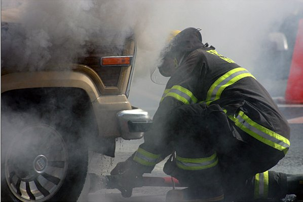 A firefighter is shown battling a Aug. 12 car fire without proper apparatus.
