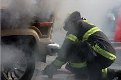 A firefighter is shown battling a Aug. 12 car fire without proper apparatus. A firefighter is shown battling a Aug. 12 car fire without proper apparatus.