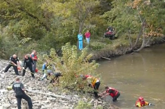The woman was cut free from her seat belt and was pulled ashore by responders tethered by a rope.