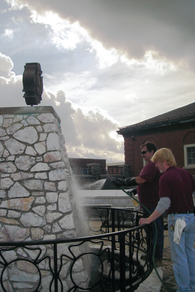John Price, left, and Dooley Hildebrand cleaned the National Fallen Firefighter Memorial on Wednesday.