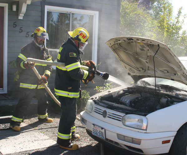 A month before a firefighter was photographed fighting a car fire without proper equipment, firefighters extinguished a car fire without proper gear.