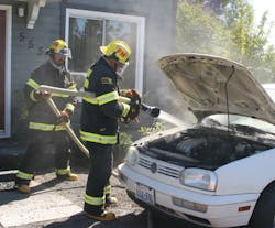 A month before a firefighter was photographed fighting a car fire without proper equipment, firefighters extinguished a car fire without proper gear. A month before a firefighter was photographed fighting a car fire without proper equipment, firefighters extinguished a car fire without proper gear.