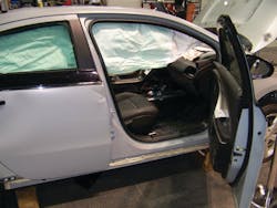 The four doors on the Chevrolet VOLT have conventional hinge and latch assemblies, a high-strength collision beam inside, and tempered-glass safety windows. Note how the deployed roof airbag obstructs patient access. The bag can be cut away by responders on scene. The four doors on the Chevrolet VOLT have conventional hinge and latch assemblies, a high-strength collision beam inside, and tempered-glass safety windows. Note how the deployed roof airbag obstructs patient access. The bag can be cut away by responders on scene.