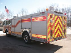 A rear chevron retrofit shows how reflective trim and chevrons enhance the appearance of an unpainted apparatus body.