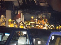 Metal handrail and parked vehicles impede recovery efforts at the front entryway. A window to the bar room is at left. Metal handrail and parked vehicles impede recovery efforts at the front entryway. A window to the bar room is at left.