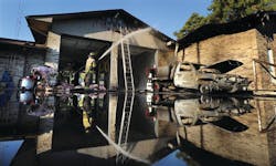 Firefighters work on hot spots at the Caddo Parish Fire District 1 after a grass truck caught fire and the fire moved into the building. Firefighters work on hot spots at the Caddo Parish Fire District 1 after a grass truck caught fire and the fire moved into the building.