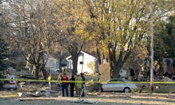 Firefighters and other emergency workers look at the remains of a house that exploded on Nov. 9. Firefighters and other emergency workers look at the remains of a house that exploded on Nov. 9.