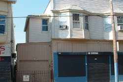 The above photo shows an old “mixed multiple” occupancy with add-ons. The original building is of Type III construction (brick and joist) while the add-ons are made of wood frame. Note the separation distance between the two structures presents an exposure concern if a fire should occur. The above photo shows an old “mixed multiple” occupancy with add-ons. The original building is of Type III construction (brick and joist) while the add-ons are made of wood frame. Note the separation distance between the two structures presents an exposure concern if a fire should occur.