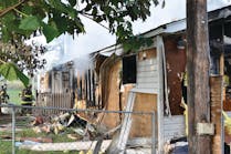 A firefighter was injured when he and another firefighter entered this mobile home to search for children who were reported by neighbors to be inside. The children were not at home at the time.