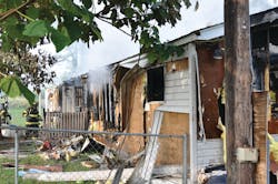 A firefighter was injured when he and another firefighter entered this mobile home to search for children who were reported by neighbors to be inside. The children were not at home at the time. A firefighter was injured when he and another firefighter entered this mobile home to search for children who were reported by neighbors to be inside. The children were not at home at the time.