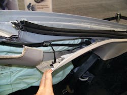 Even with the interior trim piece on the C-pillar peeled away, the steel inflator module is still not visible. The inflator unit is completely wrapped inside nylon airbag material. The exact location of the inflator can be determined by feeling with a hand to confirm exactly where it is mounted prior to cutting the rear C-pillars. Even with the interior trim piece on the C-pillar peeled away, the steel inflator module is still not visible. The inflator unit is completely wrapped inside nylon airbag material. The exact location of the inflator can be determined by feeling with a hand to confirm exactly where it is mounted prior to cutting the rear C-pillars.
