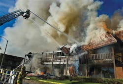 A roof begins to collapse as firefighters pour water on the blaze in Tustin, Calif. A roof begins to collapse as firefighters pour water on the blaze in Tustin, Calif.