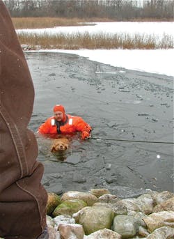 Firefighter Mike Garrison was tethered on shore and was picking his way across the ice when is gave way, sending him in the water with the dog.