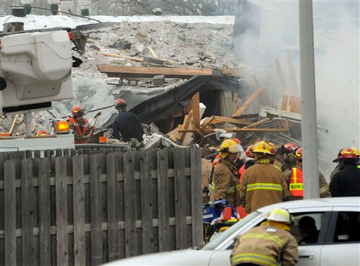 Firefighters respond after an explosion and collapse at the William C. Franks furniture store in Wayne, Mich.