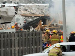 Firefighters respond after an explosion and collapse at the William C. Franks furniture store in Wayne, Mich.