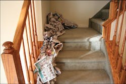 Newspaper is used to create a trailer on the stairs of a dwelling in this training prop. The trailer will move the fire from the first floor to second floor landing. Newspaper is used to create a trailer on the stairs of a dwelling in this training prop. The trailer will move the fire from the first floor to second floor landing.