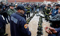 Firefighters applaud Andy Delgado, back to camera, as he tells them to keep their hopes up as they prepare to turn in their gear after being laid off. Firefighters applaud Andy Delgado, back to camera, as he tells them to keep their hopes up as they prepare to turn in their gear after being laid off.