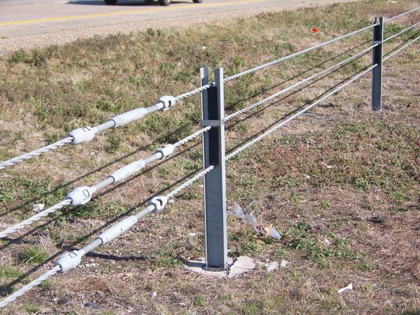 Cable barrier median systems all use steel turnbuckles to pull tension on sections of cable that can be up to 1,000 feet in length. During an impact with a vehicle, the weak support posts fail as the tensioned cables work to restrain and redirect the out-of-control vehicle.