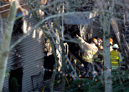 Redmond firefighters and investigators insepct the scene of an apartment fire that claimed the lives of five people.