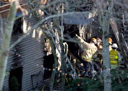 Redmond firefighters and investigators insepct the scene of an apartment fire that claimed the lives of five people. Redmond firefighters and investigators insepct the scene of an apartment fire that claimed the lives of five people.
